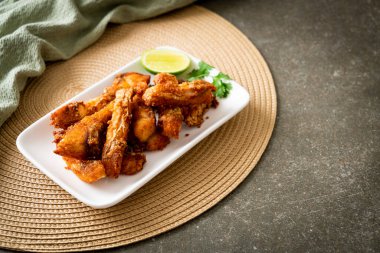 Fried Snapper Belly on white plate - Asian food style