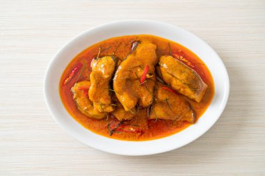 Redtail Catfish Fish in Dried Red Curry Sauce that called Choo Chee or a king of curry cooked with fish served with a spicy sauce