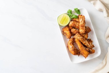 Fried Snapper Belly on white plate - Asian food style