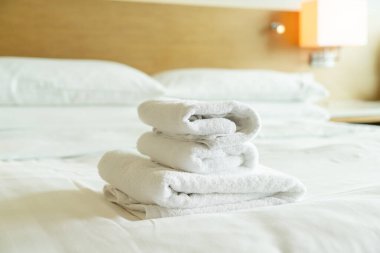 close-up white towel stack on bed