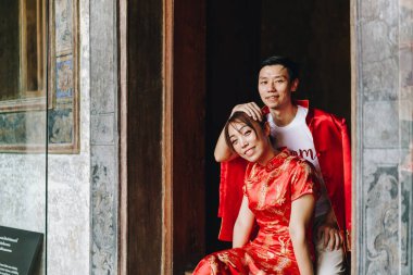 Happy young Asian couple love in Chinese traditional dresses - Red is the main color of the traditional festive that including wedding in China.