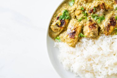 Afghani chicken in green curry or Hariyali tikka chicken hara masala with rice - Asian food style