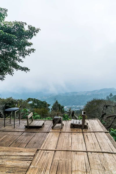 empty chair on balcony with mountain hill and foggy background