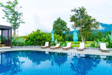 pool bed around swimming pool with mountain hill background - Holidays and vacation concept