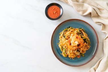 Karıştırılmış hazır erişteli sukiyaki, karidesli, Asya usulü.