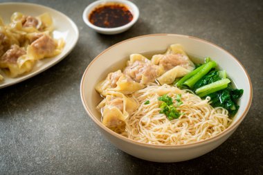 egg noodles with pork wonton soup or pork dumplings soup and vegetable - Asian food style clipart
