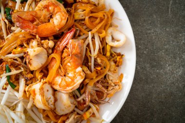 Pad Thai Seafood - Stir fried noodles with shrimps, squid or octopus and tofu in Thai style clipart