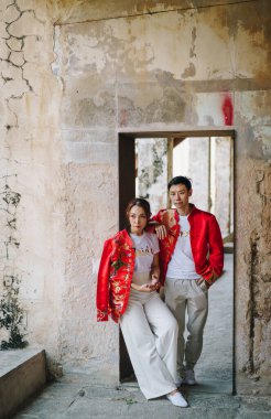 Happy young Asian couple love in Chinese traditional dresses - Red is the main color of the traditional festive that including wedding in China.