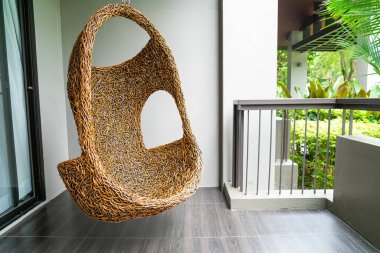 empty wicker swing on blacony for relaxing