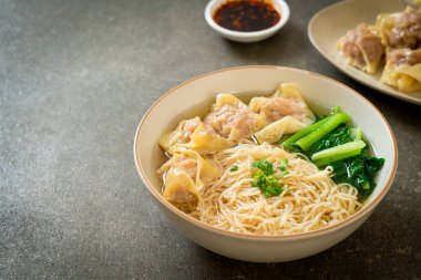 egg noodles with pork wonton soup or pork dumplings soup and vegetable - Asian food style clipart