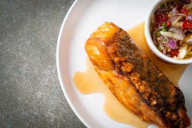 fried snapper fish with fish sauce and spicy salad - Asian food style