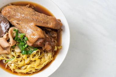 Kahverengi çorbada haşlanmış ördek ve haşlanmış yumurtalı şehriye Asya yemeği.