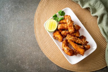 Fried Snapper Belly on white plate - Asian food style