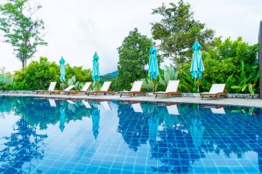pool bed around swimming pool with mountain hill background - Holidays and vacation concept