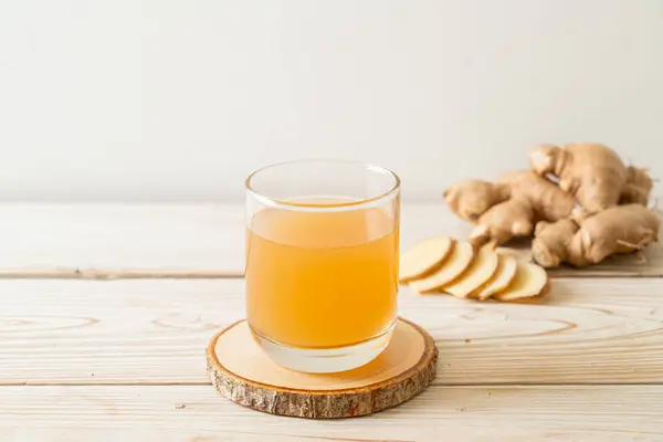 stock image fresh and hot ginger juice glass with ginger roots - Healthy drink style