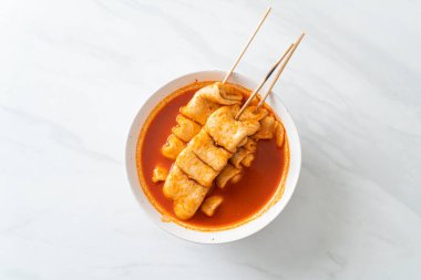 Odeng - Korean fish cake skewer in Korean spicy soup - Korean street food style clipart