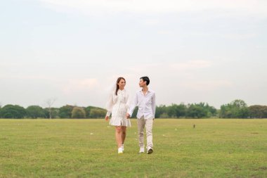 Gelin ve damat kıyafetli mutlu genç Asyalı çift evlenmeye ve evlenmeye hazır.