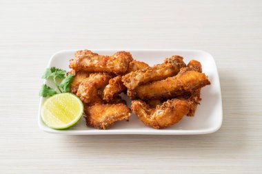 Fried Snapper Belly on white plate - Asian food style