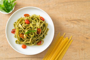 pesto soslu ve domatesli makarna vejetaryen ve vejetaryen yemek tarzı.