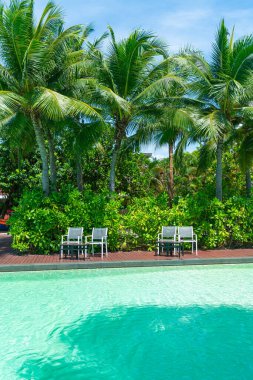 empty chair around swimming pool - Holidays and vacation concept