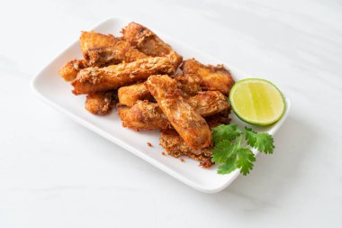 Fried Snapper Belly on white plate - Asian food style