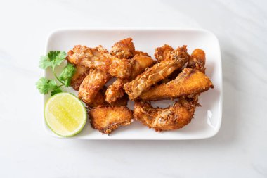 Fried Snapper Belly on white plate - Asian food style