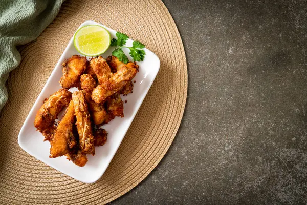 Fried Snapper Belly on white plate - Asian food style