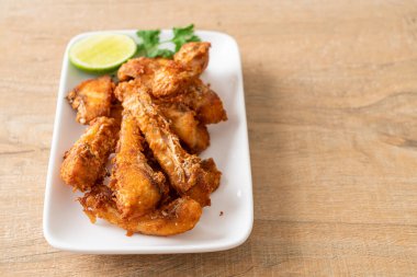 Fried Snapper Belly on white plate - Asian food style