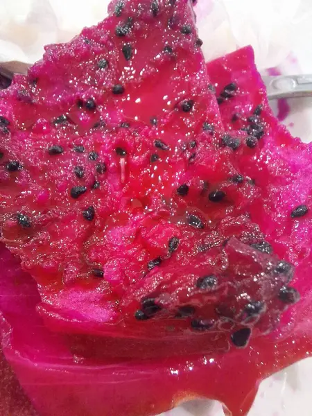 a bite of bright red dragon fruit