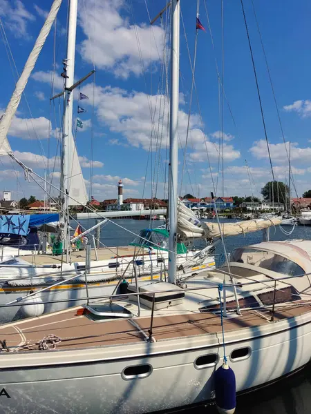 stock image Timmendorf - Island Poel - Germany - Sailboat in Marina with Lighthouse in the Background on a Sunny Day