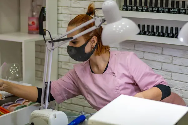 Beyaz önlüklü bir kadın, beyaz tıbbi maskeli bir maske.