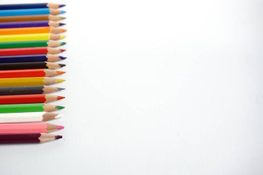 Çizim için beyaz defter kağıdının üzerine çok renkli kalemler koyun. okul konseptine geri dön.