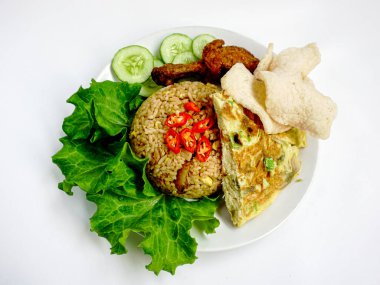 fried rice, chicken and vegetables on a white plate. Nasi Goreng - Indonesian Chicken Fried Rice on white plate isolated on white backdrop. Nasi Goreng is an Indonesian cuisine dish. Balinese Food. Asian meal. Top view clipart