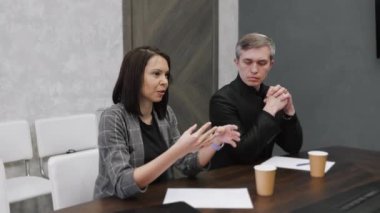 Ofisteki iş toplantısında kadın takım lideri yöneticilerle konuşuyor, strateji planlıyor. Bütünlük kavramı