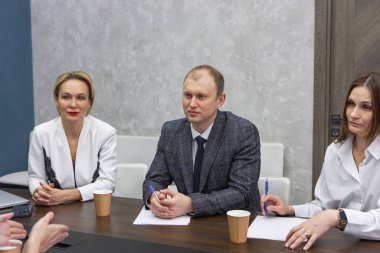 Business meeting in modern office, successful managers discussing project, sharing ideas. Colleagues working together, planning strategy. Concept of business