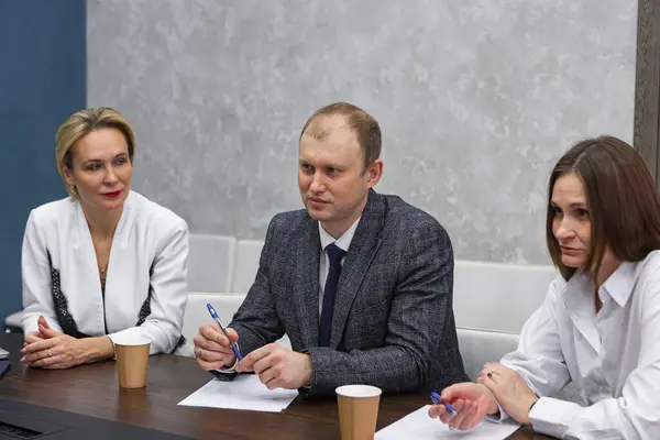 Business meeting in modern office, successful managers discussing project, sharing ideas. Colleagues working together, planning strategy. Concept of business