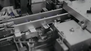 Otomatik robot paketleyici kutuları kremayla kapatıyor. Kozmetik üretimi ve ambalaj fabrikası. Kozmetik için karton kutular. Fabrikada otomatik kozmetik ambalajı. Karton kutu üretimi.