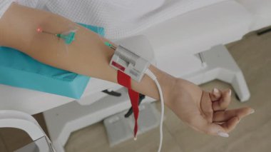 Bir kadın damar içi lazer kan radyasyonundan modern bir prosedür geçirir. Kan radyasyonunun tıbbi prosedürü. Modern tıp. UV kan radyasyon terapisi. 