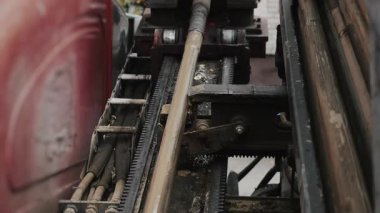 The machine operates horizontally at an inclined angle when laying pipes in the ground. The HDD machine makes a hole in the ground for laying underground utilities.