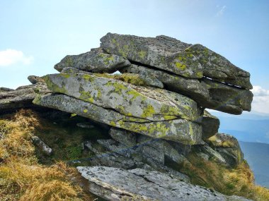 Rock formation on a tourist mountain route against the sky. The diversity of the Ukrainian Carpathians clipart