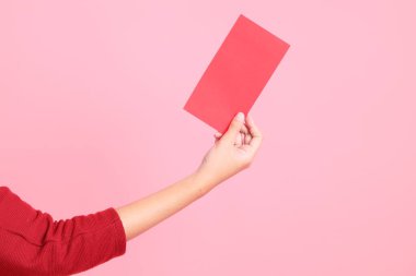 Mutlu Çin Yeni Yılları, pembe arka planda Çin kırmızı zarfları tutan kırmızı tişörtlü Asyalı bir kadının eli.. 