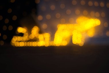 Kendinizi bu şenlikli bokeh 'in büyüleyici atmosferine daldırın, 75 mm' lik bir objektifle tam kare bir kameraya yakalandınız. Görüntü, parıldayan ışıklar ve altın bir Ch ile süslenmiş bir kızağı çeken bir ren geyiğinin bulanık ama tanınabilir bir siluetini gösteriyor.