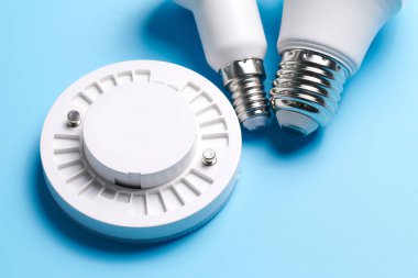 Loş düğmeli elektrik ışığı ayarlandı, kontrol edilebilir ışıklandırma. Enerji tasarrufu kavramı, mavi arkaplanda izole edilmiş elektrik gücünü değiştirmek için tasarlanmış aygıt