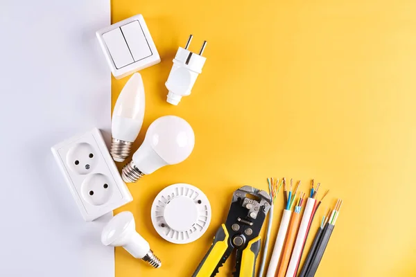 Electric tools set with dimmer switch isolated on yellow white background with copy space, controllable lighting. Saving energy concept, building and renovation