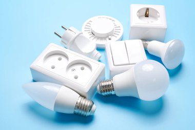 Loş düğmeli elektrik ışığı ayarlandı, kontrol edilebilir ışıklandırma. Enerji tasarrufu kavramı, mavi arkaplanda izole edilmiş elektrik gücünü değiştirmek için tasarlanmış aygıt