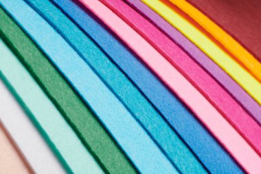 Multi-colored soft felt textile material, colorful patchwork texture fabric close-up