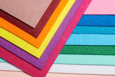 Multi-colored soft felt textile material, colorful patchwork texture fabric close-up