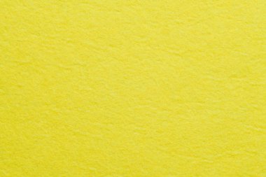 Soft felt textile material yellow color, colorful texture flap fabric background closeup