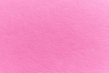 Soft felt textile material pink color, colorful texture flap fabric background closeup