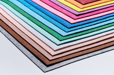 Multi-colored soft felt textile material, colorful patchwork texture fabric close-up